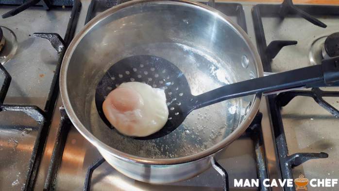 Lifting poached egg from water