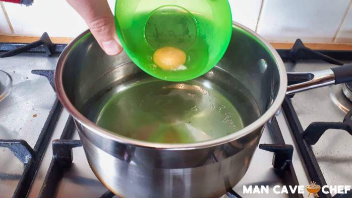 Lower egg into water using a bowl